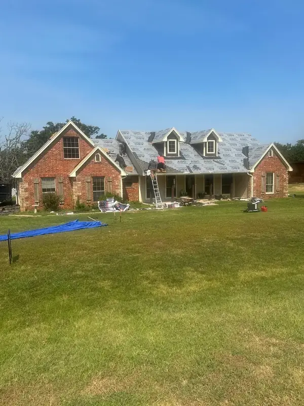 Roof underlayment installation on brick home